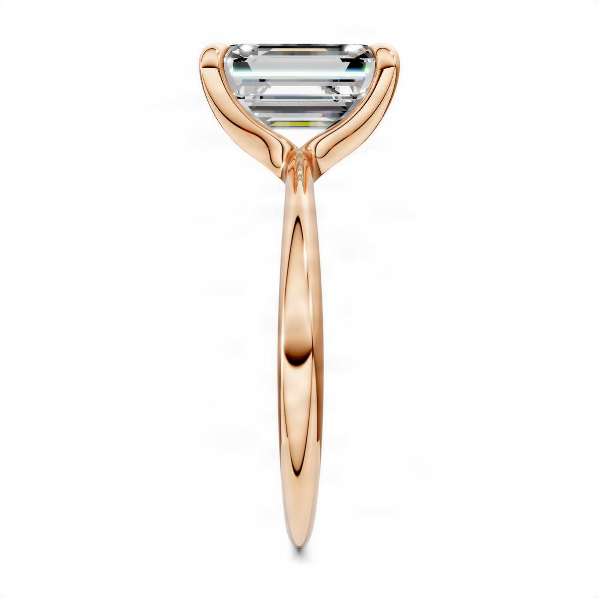 Rose gold solitaire ring with emerald-cut center stone, slim tapered shank