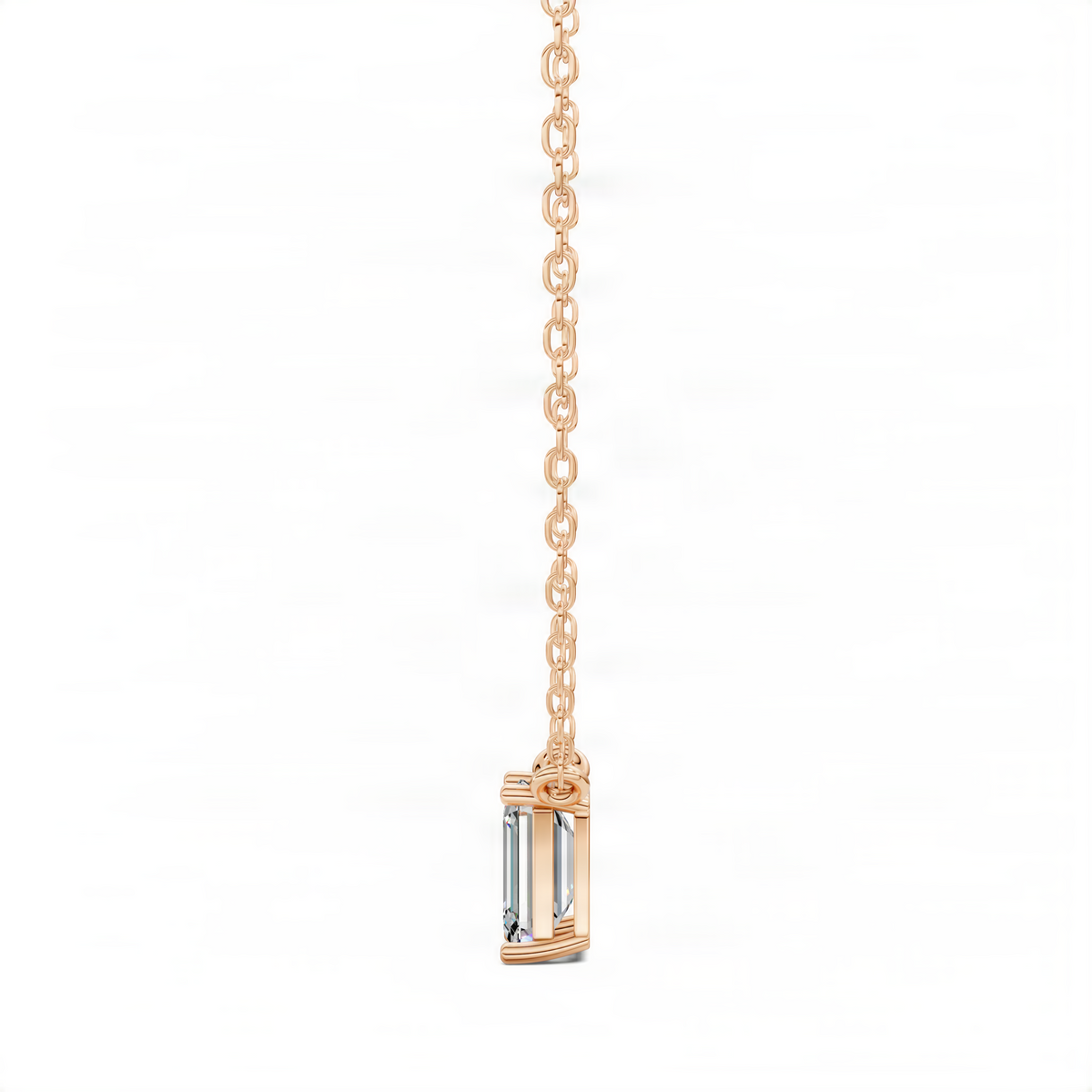Rose gold diamond pendant on chain with emerald-cut center stone in a bezel setting