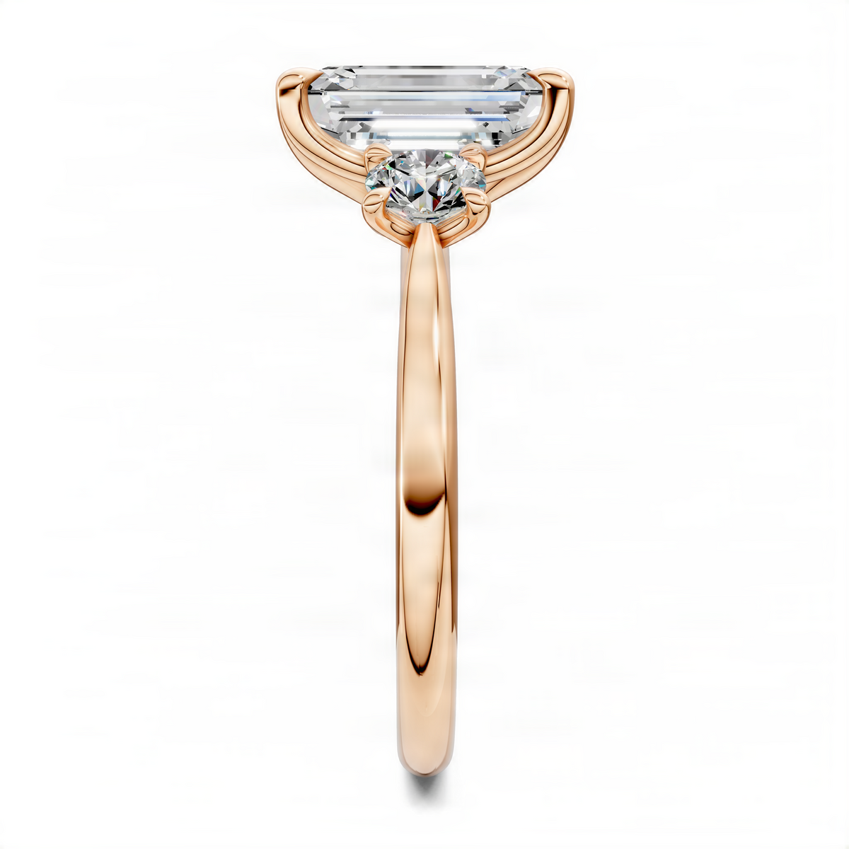 Three-stone ring front view with emerald-cut center and round side stones, rose gold