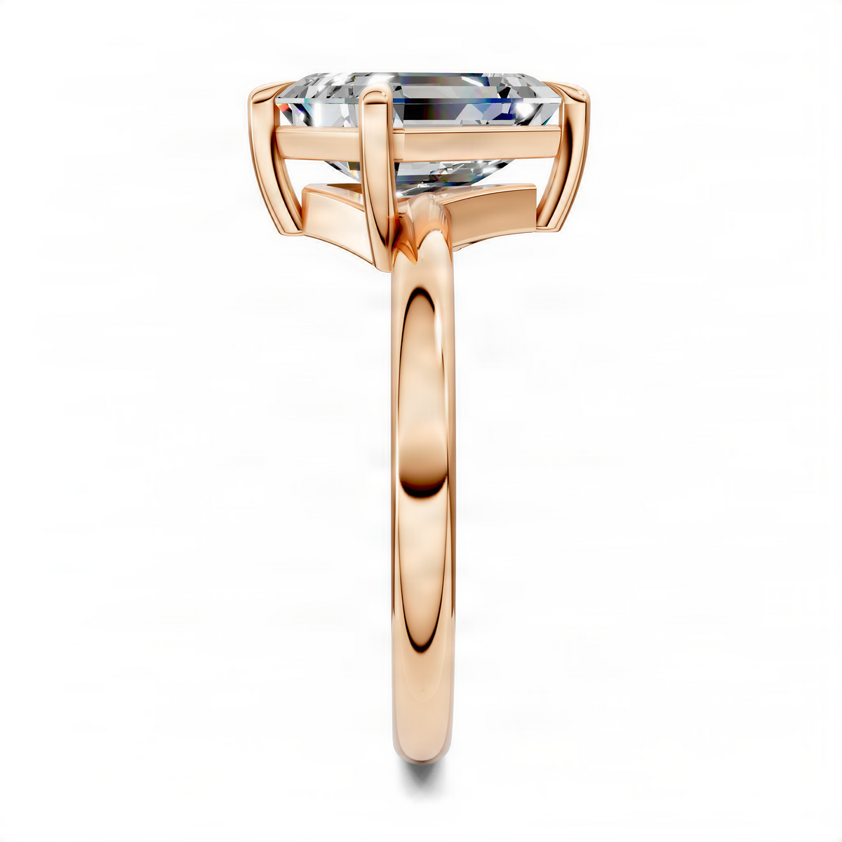 Rose gold solitaire ring featuring an emerald-cut stone in a tapered four-prong setting