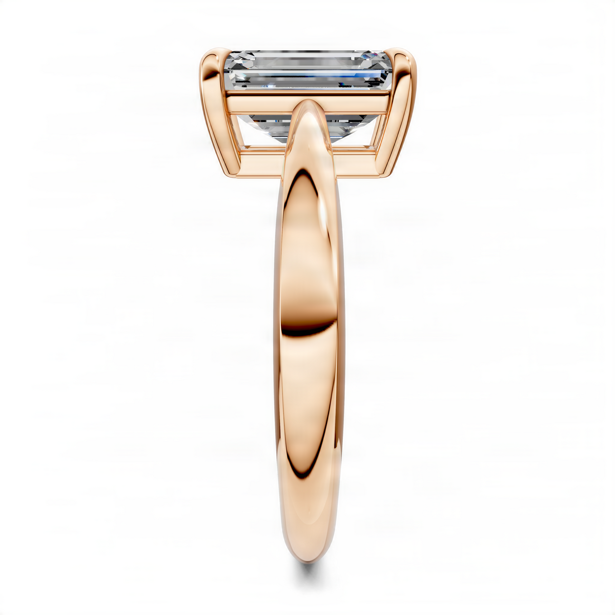 Rose gold tapered solitaire ring with rectangular emerald-cut center stone and four prongs