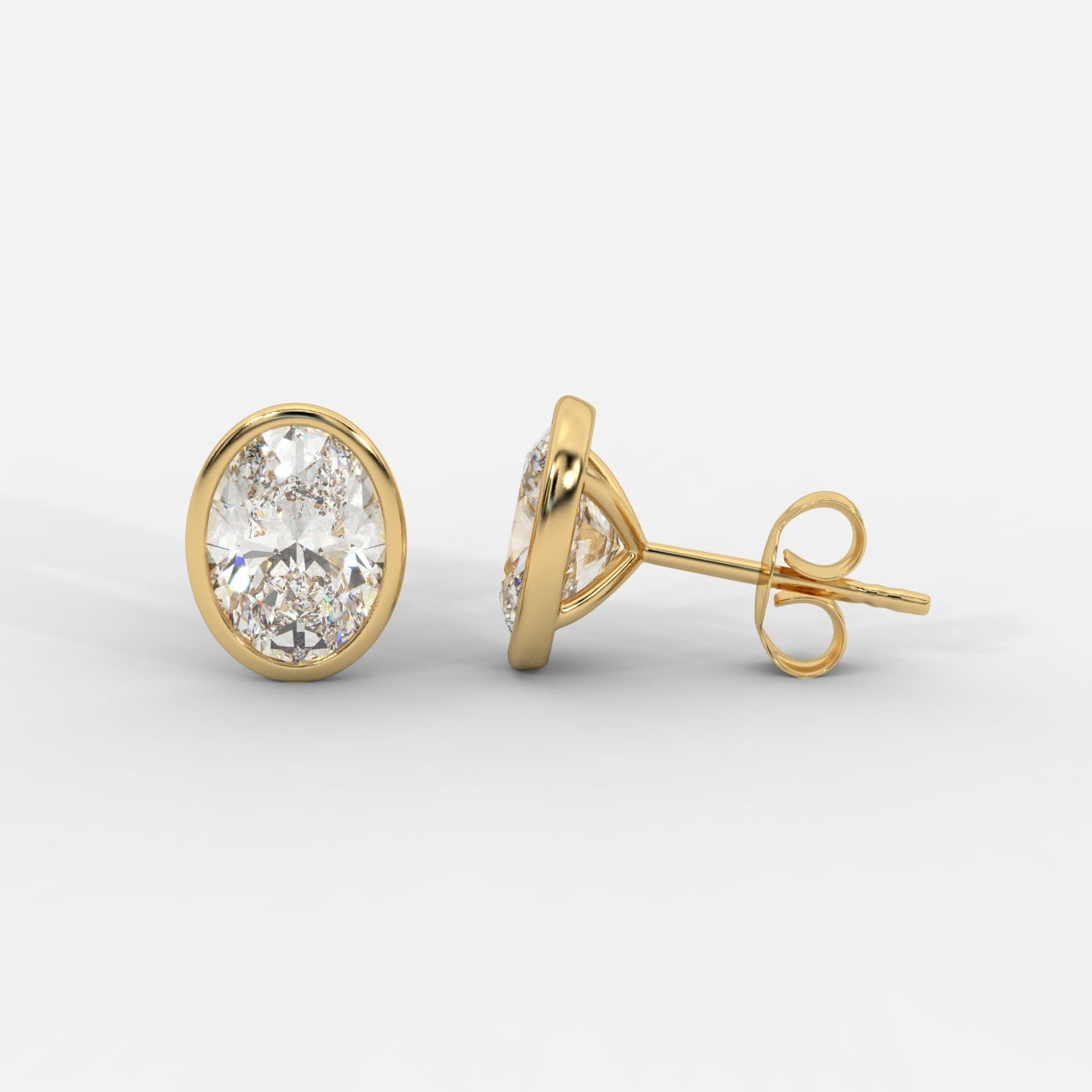 Oval cut lab grown diamond bezel stud earrings in gold by Opes & Co