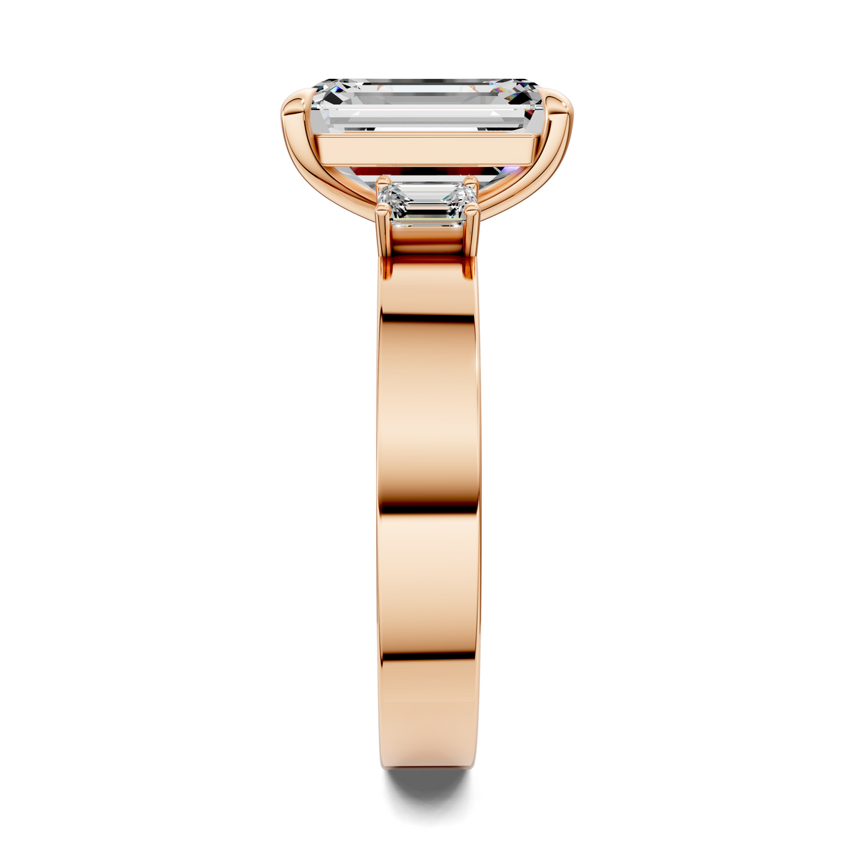Rose gold three-stone ring with baguette center stone and side stone settings