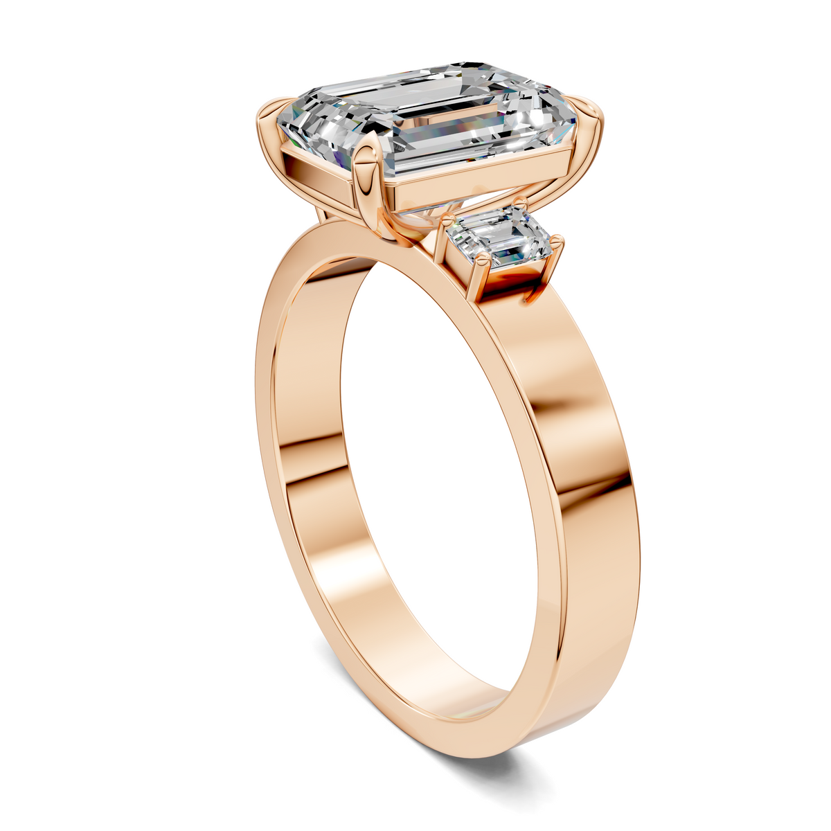 14K rose gold three-stone ring angled view, showing the emerald-cut center stone