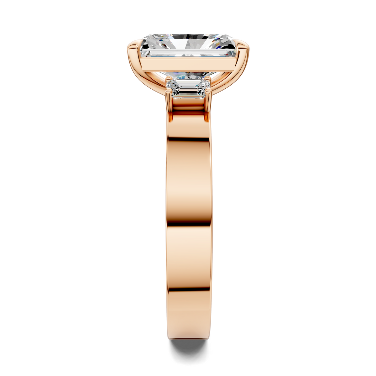 Rose gold three-stone ring, baguette center stone with side stones on prongs