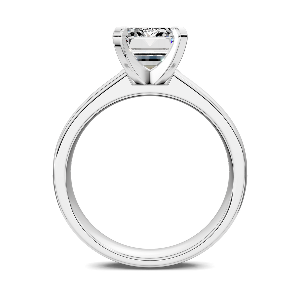 White metal ring with emerald-cut center setting and prongs, smooth band visible.