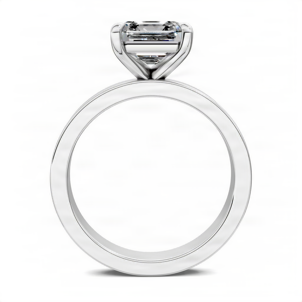 White gold solitaire ring with an emerald-cut center stone in a prong setting