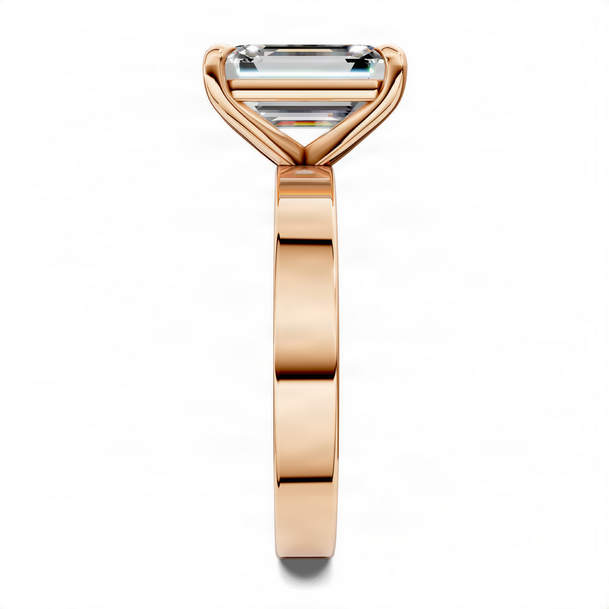 Rose gold solitaire ring with rectangular stone, close-up of prongs and slim band