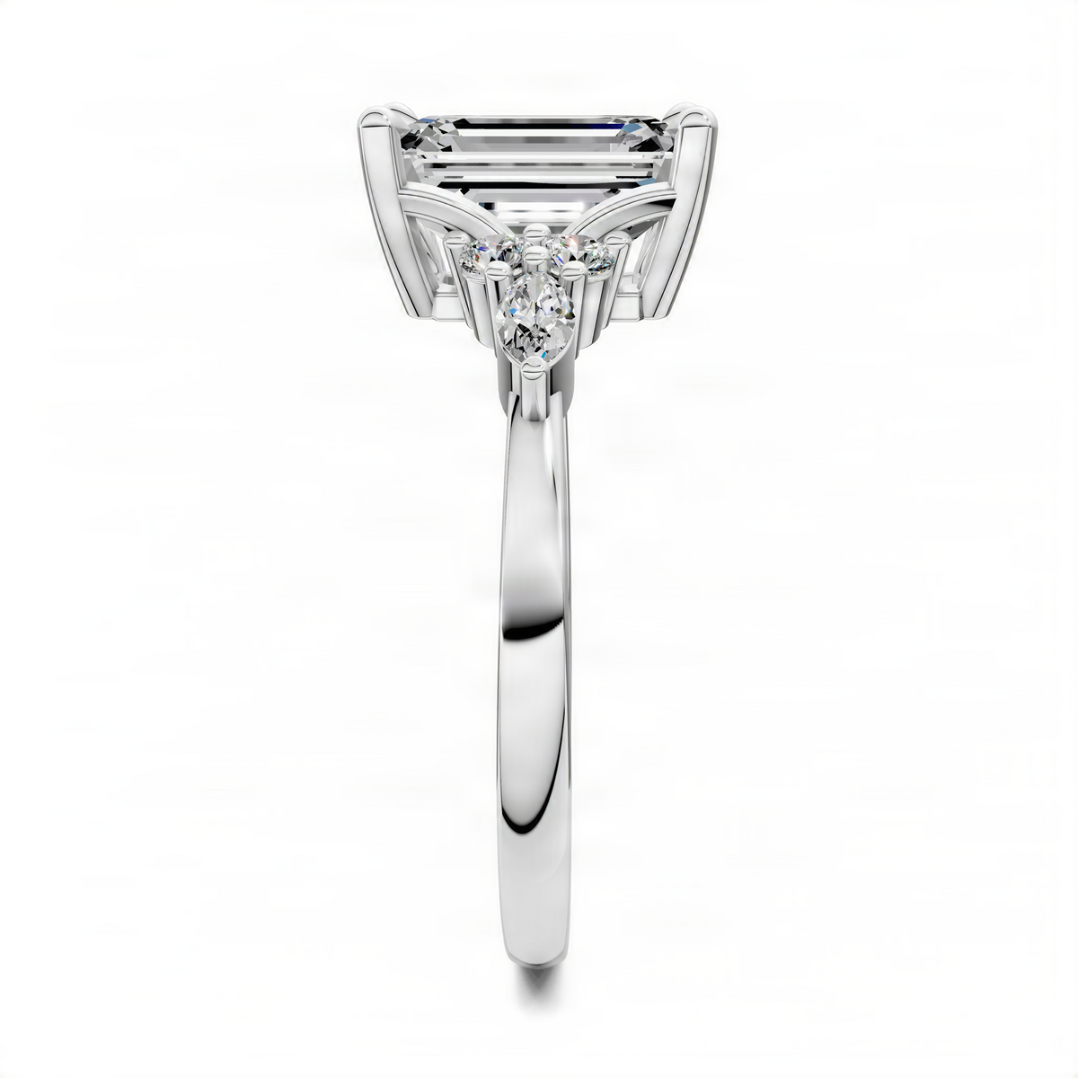 White metal engagement ring with emerald-cut center stone and pear-shaped side stones