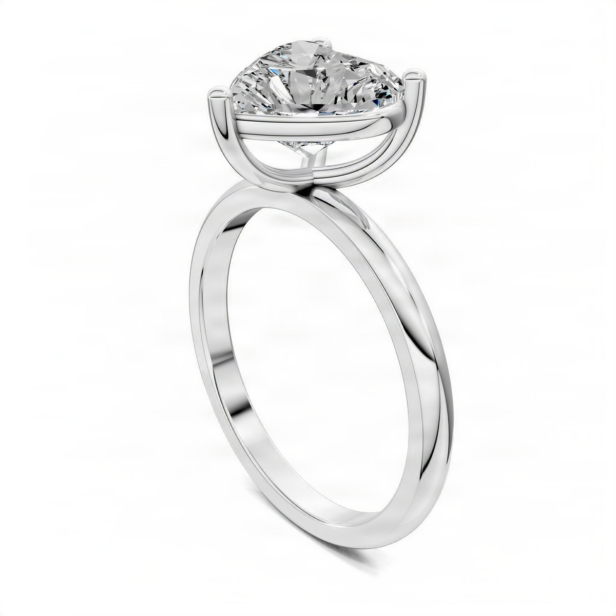 White gold solitaire engagement ring showing heart-shaped diamond in curved bezel prongs