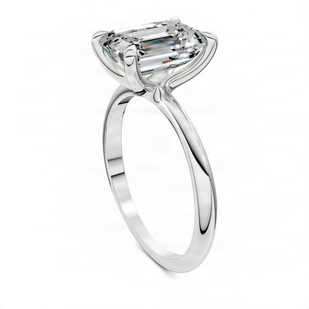 White gold solitaire ring with emerald-cut center stone and split prongs