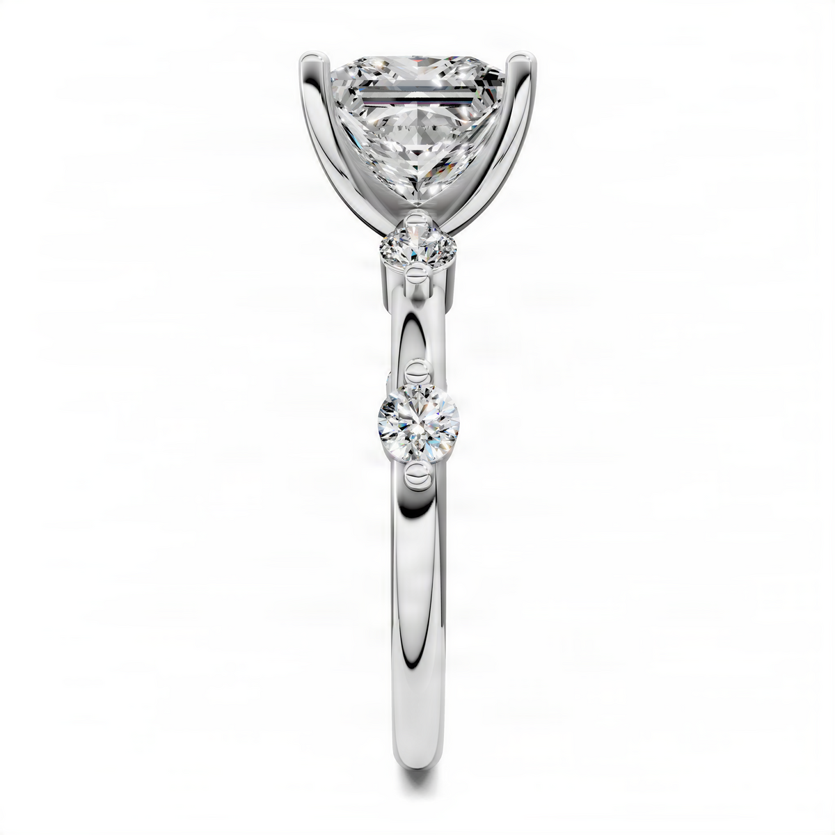 Silver-toned princess-cut diamond ring with round side diamonds stacked on the band
