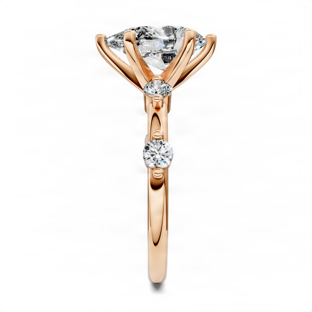 Rose gold pear accent ring with pear center stone and round diamond accents