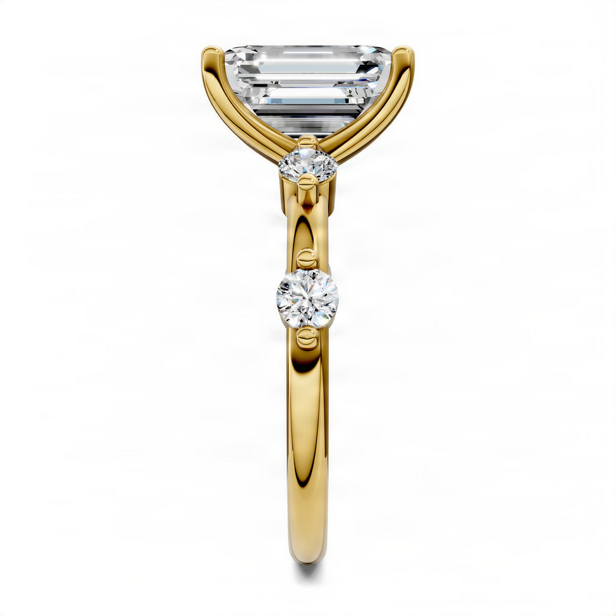 Yellow gold ring with emerald-cut stone and a round diamond accent on the band