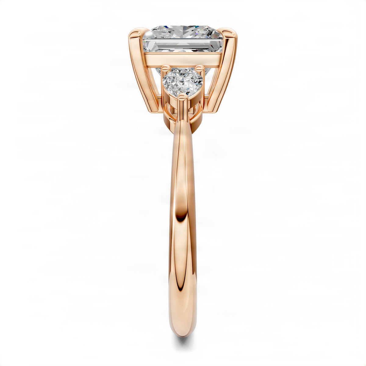 Rose gold three-stone ring viewed from the side, with rectangular center diamond