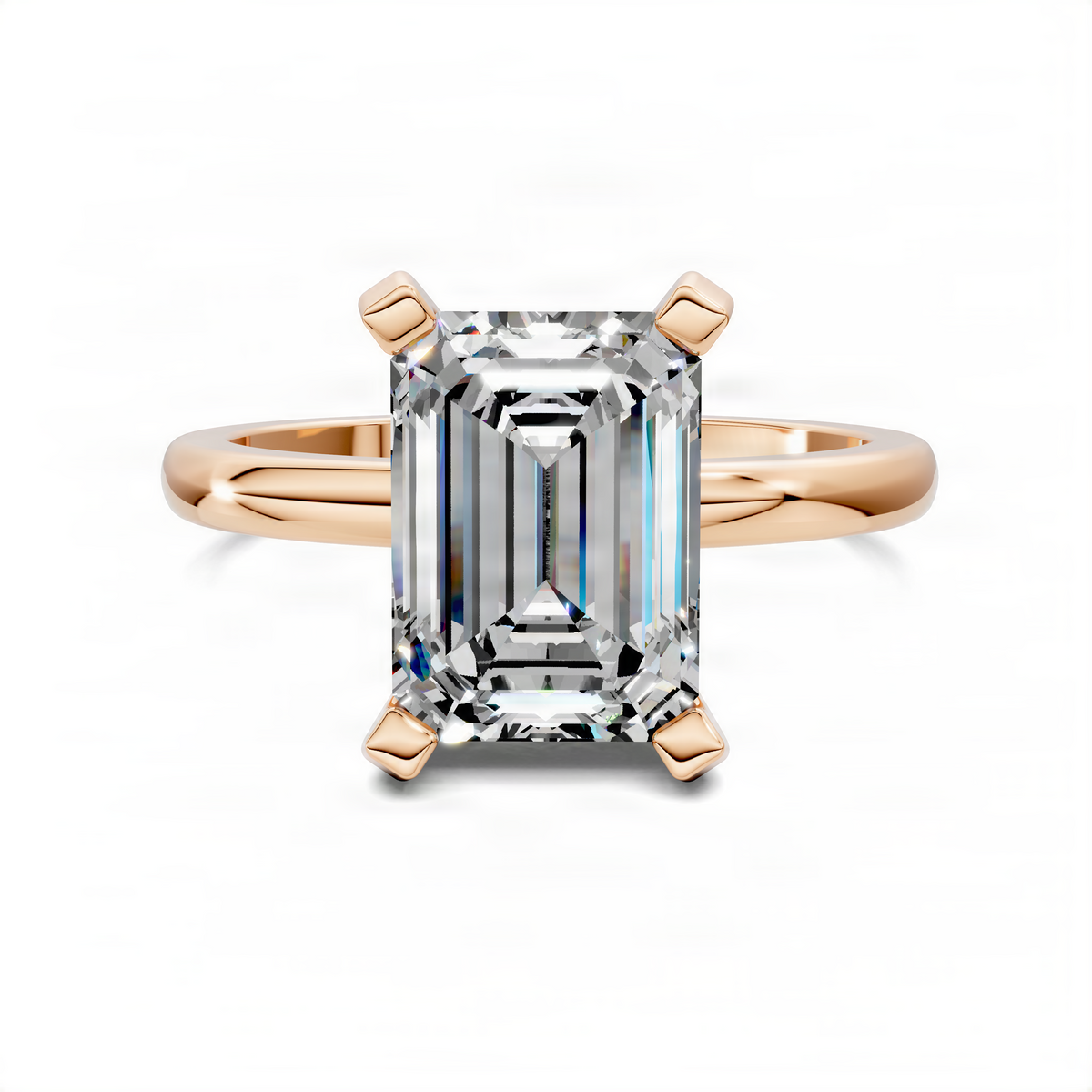 Rose gold emerald-cut solitaire ring with four prongs and faceted center stone