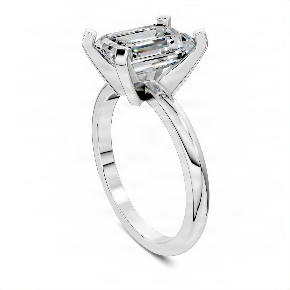 Solitaire ring with rectangular-cut center stone in four-prong setting, polished metal band