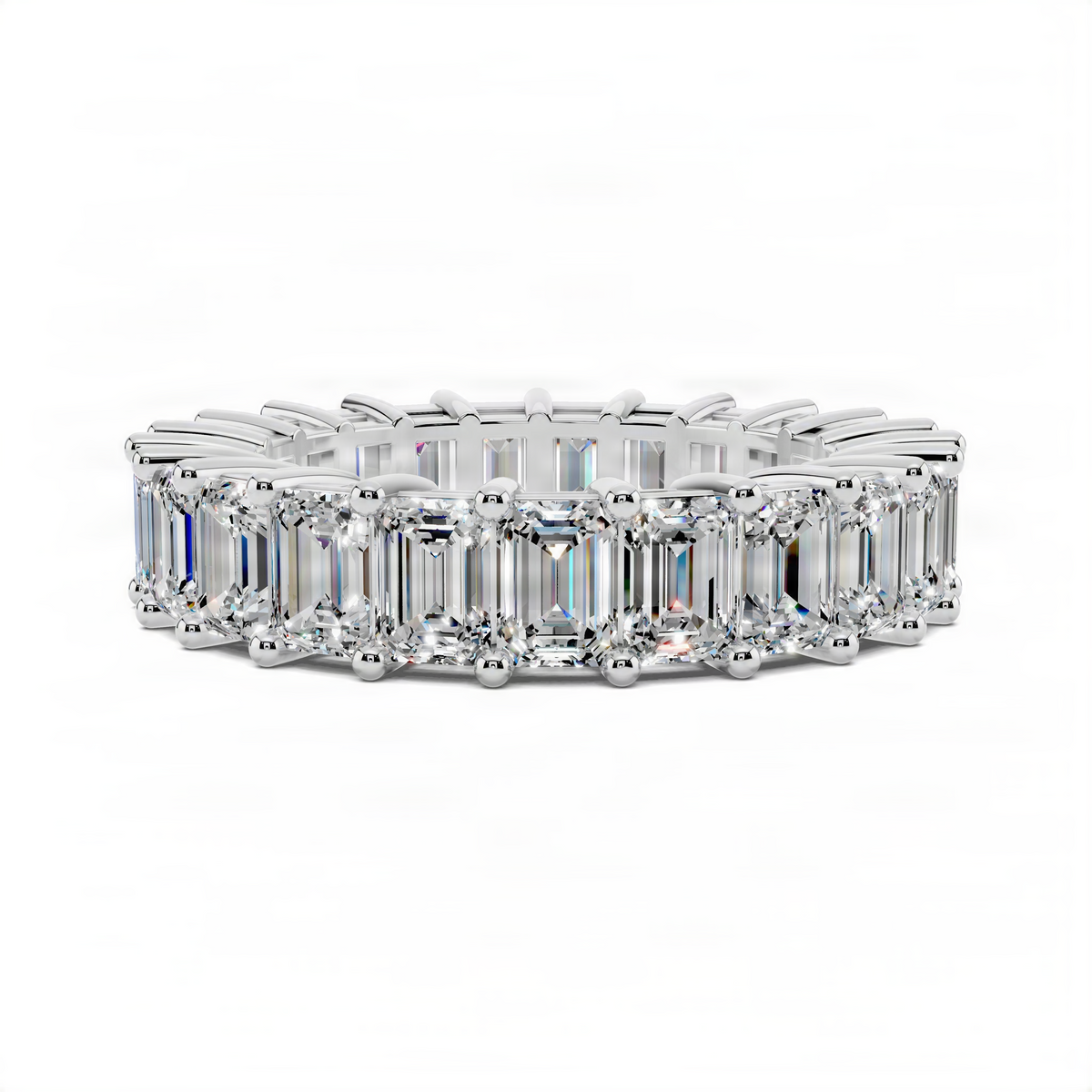 White gold eternity band ring with emerald-cut gemstones in prong settings