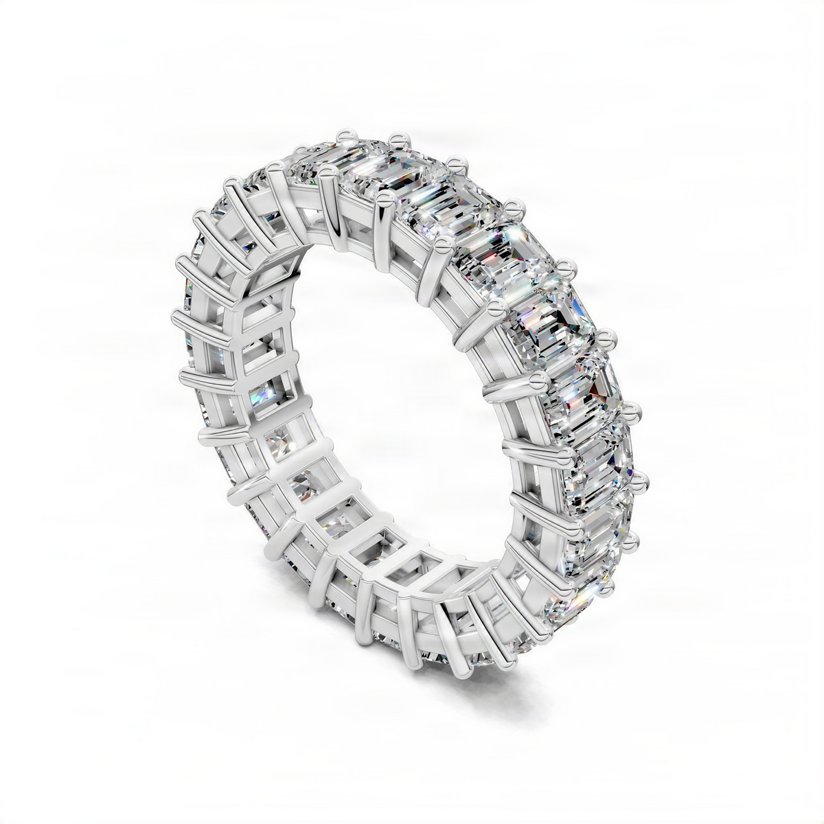 White gold eternity band ring, side view with emerald-cut gemstones in prong settings