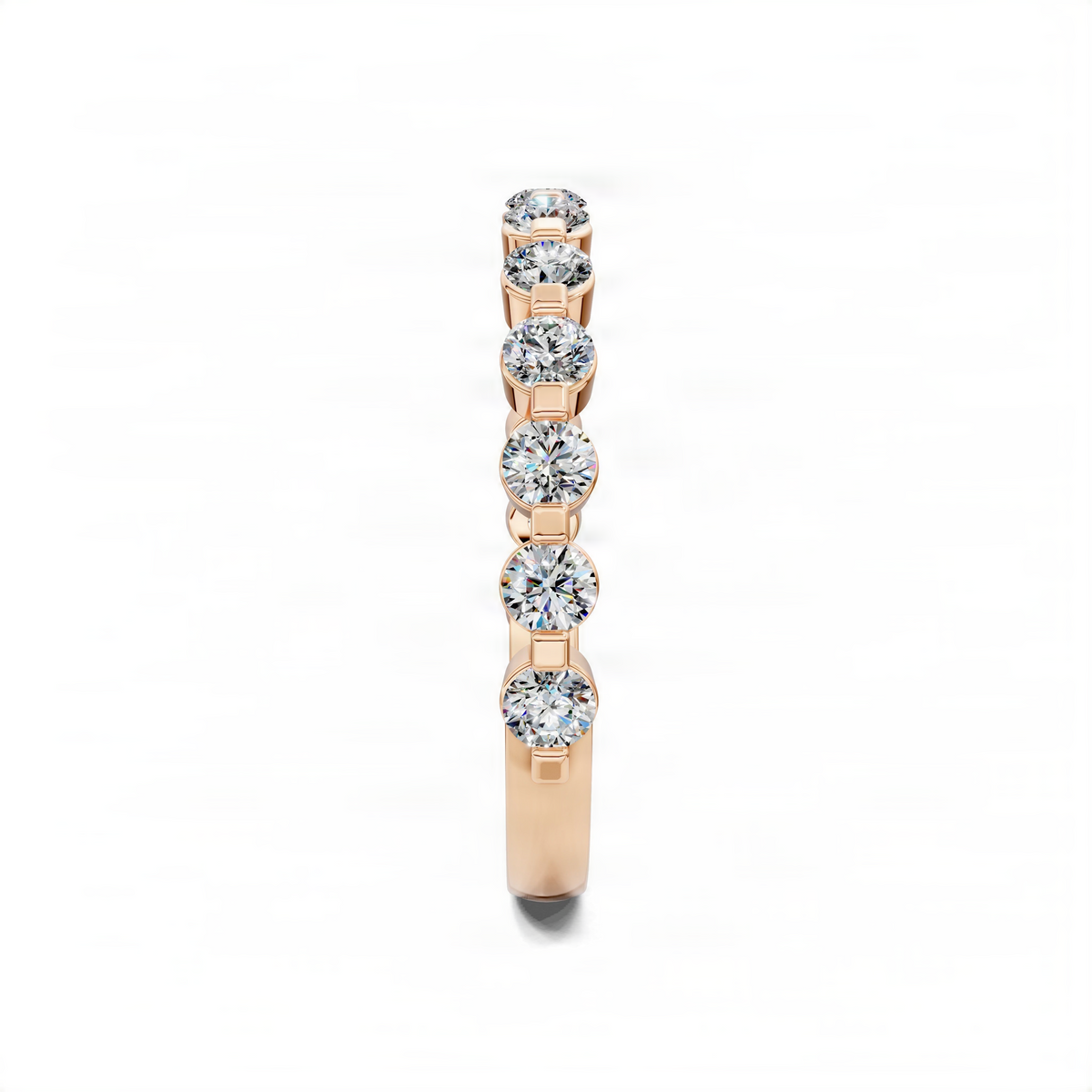 Rose gold wedding band with bezel-set round diamonds along the center row