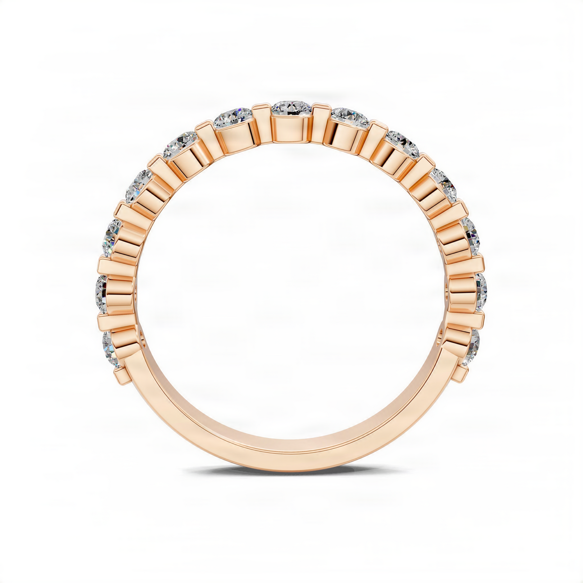 Rose gold wedding band with a row of diamond accents and polished settings