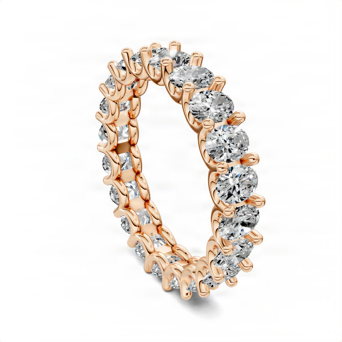 Oval eternity ring in rose gold with oval diamond bezels along the band