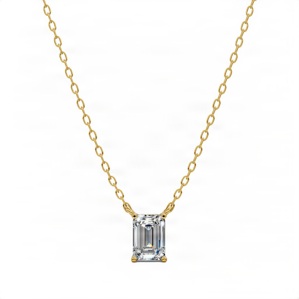 Yellow gold diamond pendant on chain with emerald-cut center stone and small side stones