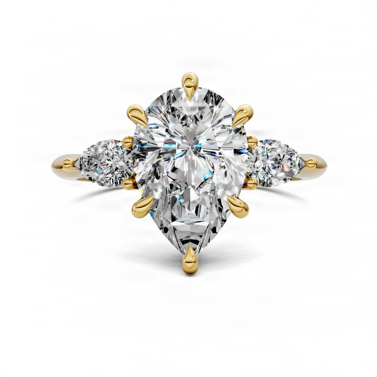 Yellow gold three-stone ring featuring a pear-cut center diamond and two side diamonds