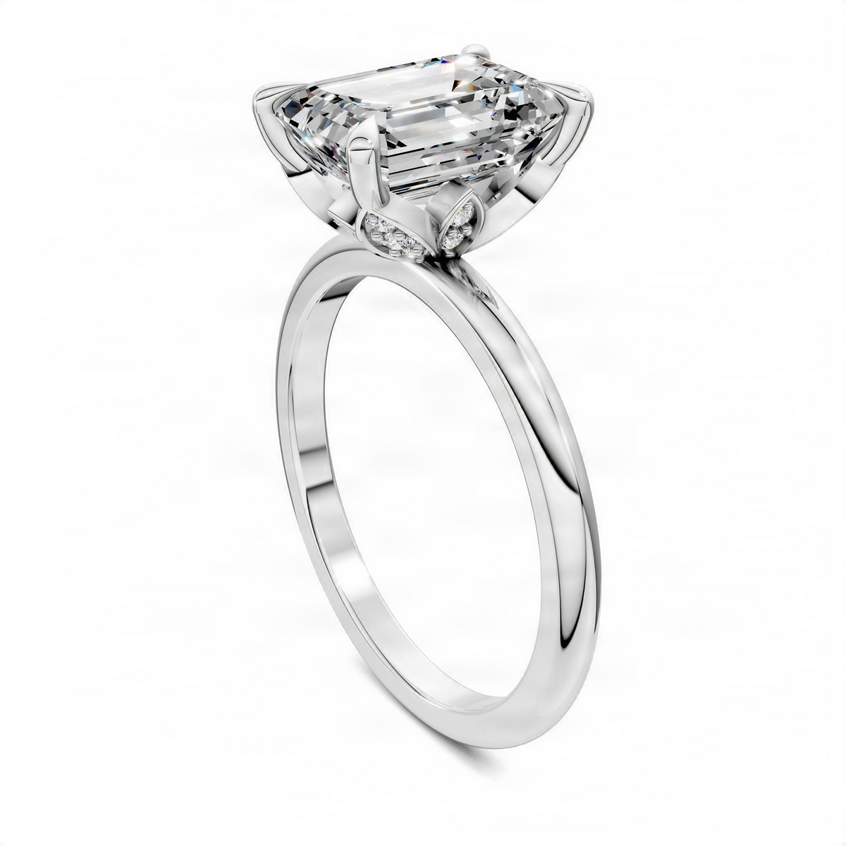 White gold engagement ring with emerald-cut center stone and leaf-shaped shoulders