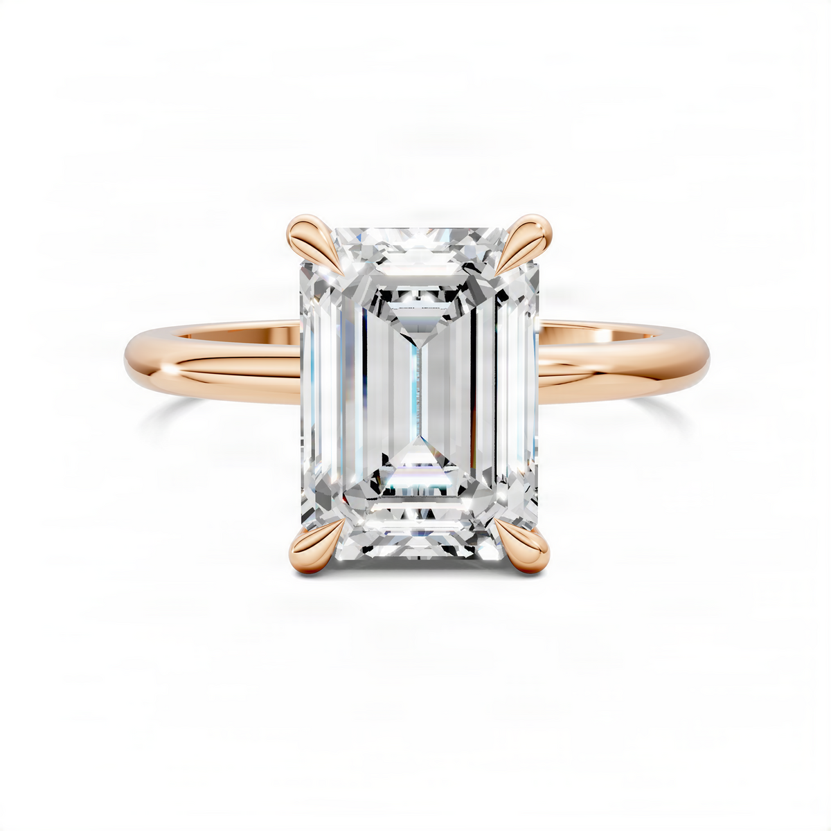 Rose gold-tone emerald-cut stone ring with leaf accents and prong-set side stones