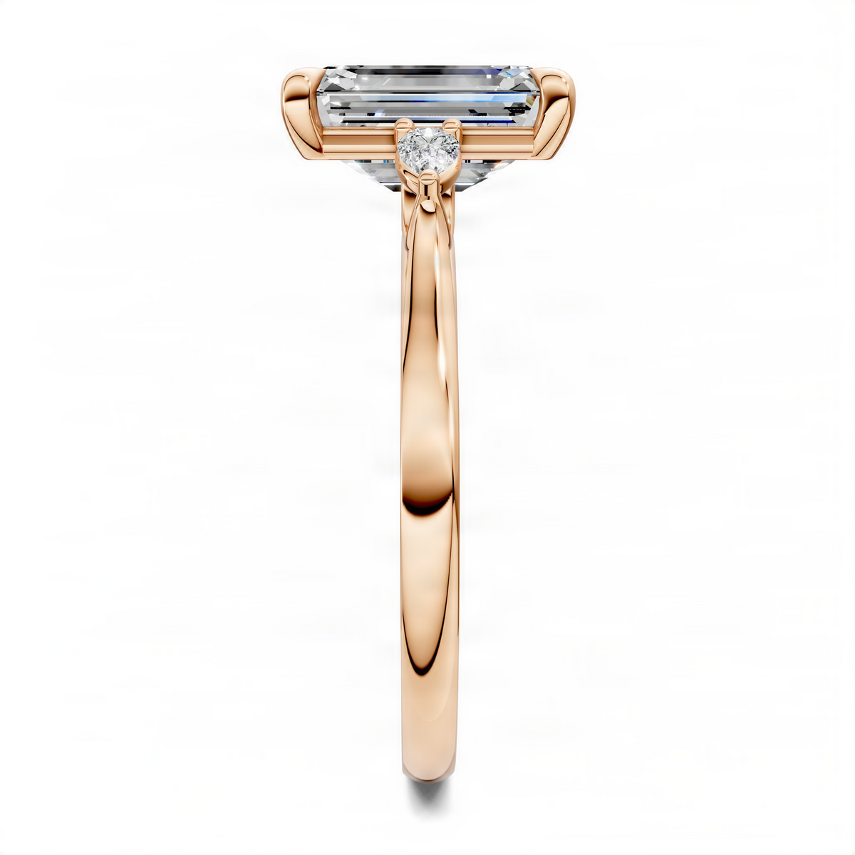 Rose gold three-stone ring with emerald-cut center stone and small side stones in prongs