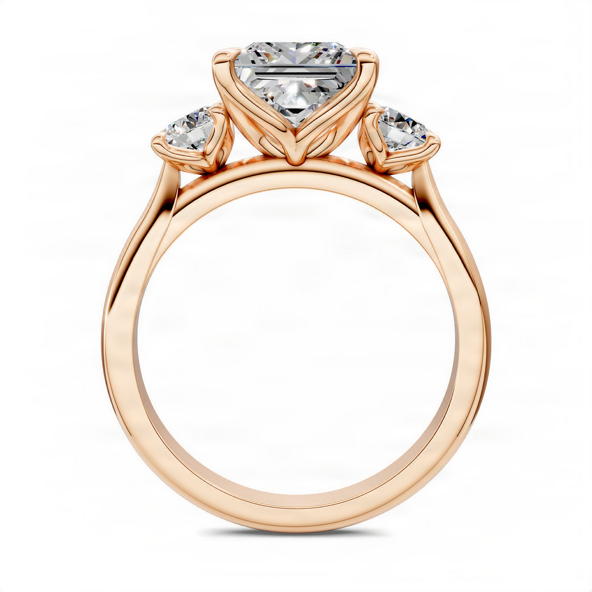 Three-stone engagement ring in rose gold with large center gemstone and two side stones