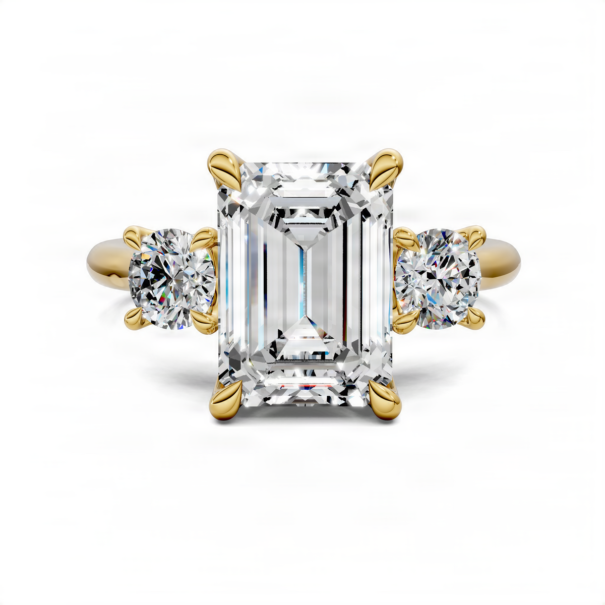 Three-stone ring with emerald-cut center stone and round side stones, yellow gold