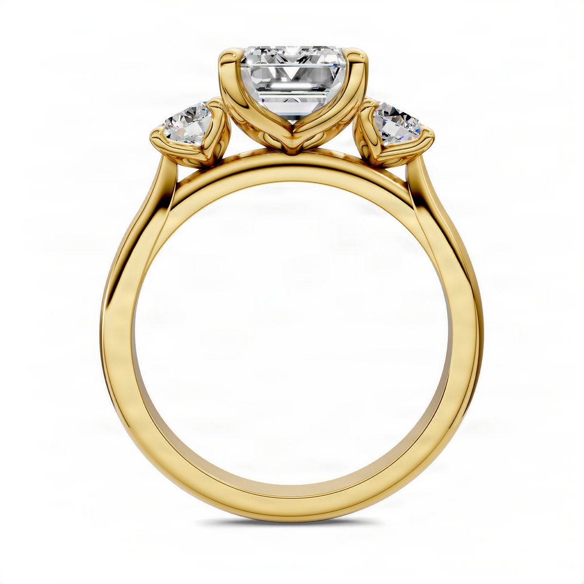 Three-stone ring top view with emerald-cut center and round side stones, yellow gold