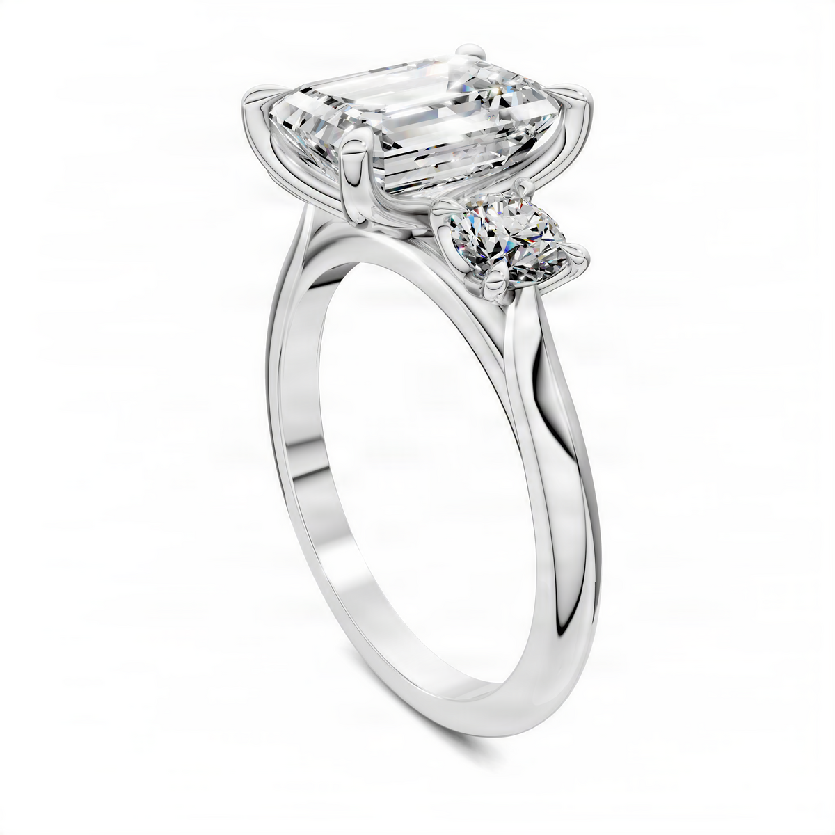 Three-stone ring side view with emerald-cut center and round side stones, white gold