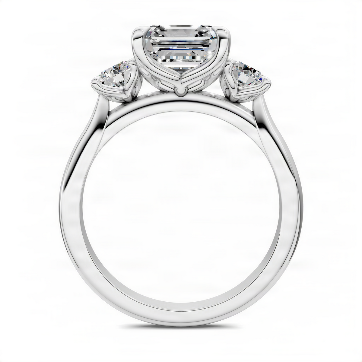 Three-stone Asscher-cut engagement ring top view with side round diamonds, white metal.