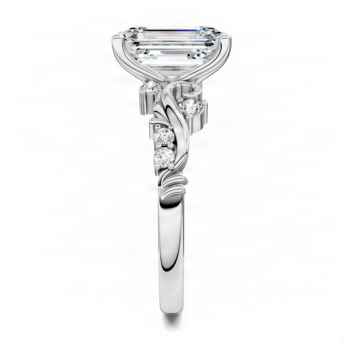 White gold engagement ring with emerald-cut center stone and diamond swirl scrollwork