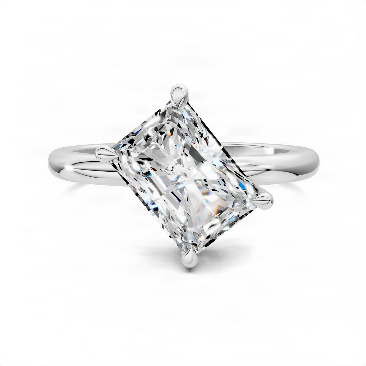 White gold solitaire ring with large emerald-cut diamond and side prongs