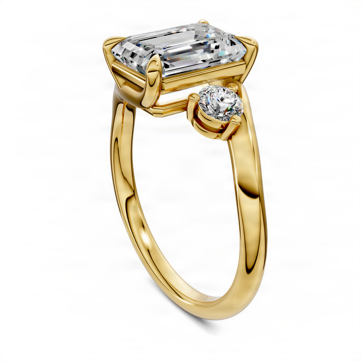Three-stone bypass ring in yellow gold with emerald-cut center and round side stones, side view