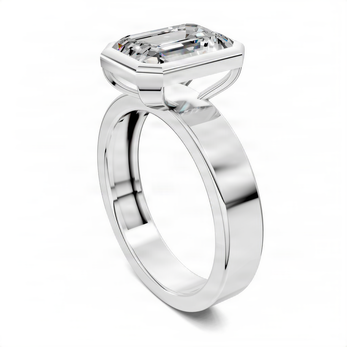 White gold bezel solitaire ring with emerald-cut center stone, slim side profile