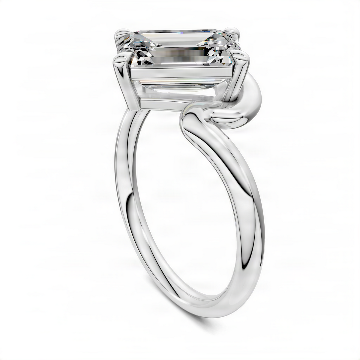 White gold emerald-cut solitaire ring with four-prong top and sculpted band