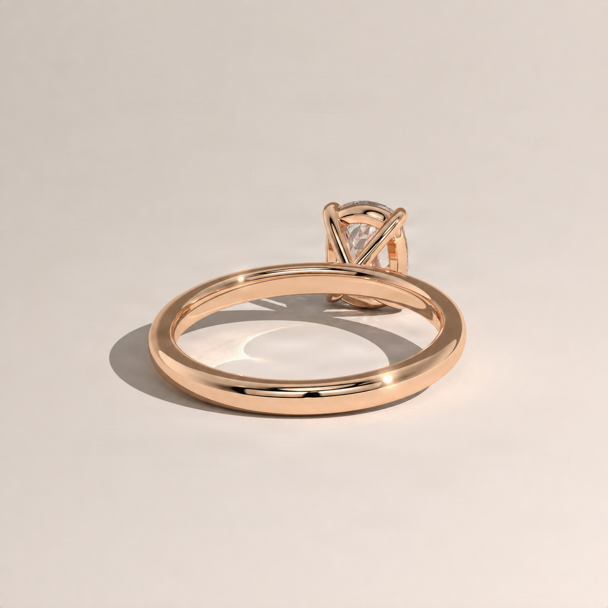 Rose gold cushion solitaire ring with prong-set cushion diamond, angled view