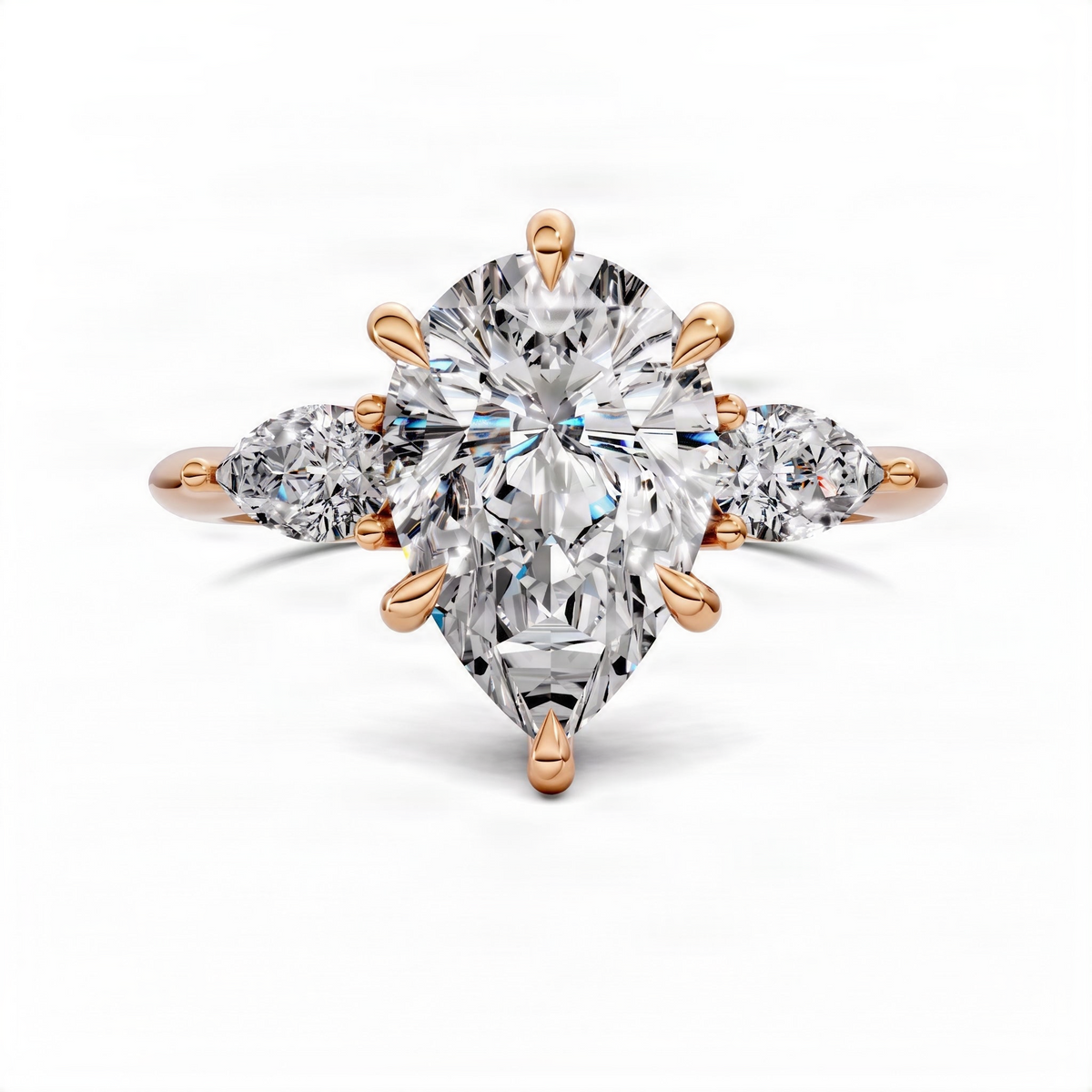 Rose gold three-stone pear-cut diamond ring with a large center pear and two side stones